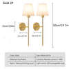 A pair of gold LED wall sconces with fabric shades and remote control, designed for bedroom or living room lighting.