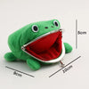 A green plush frog coin purse with a red lining is shown next to a ruler for scale.
