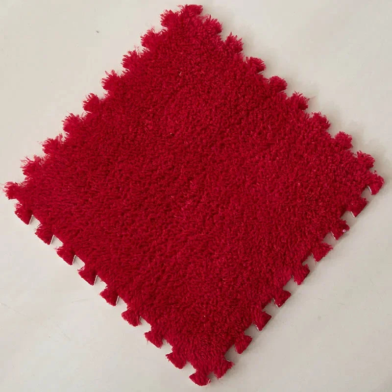 A square red plush interlocking floor tile with a textured surface.