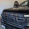 Close-up of the front grille and headlight area of a black Ford Ranger Raptor with amber LED grille lights installed.