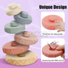 A set of eight soft silicone stacking rings in various pastel colors for baby sensory play and teethering