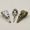 A set of five gothic skull and crow head charms for jewelry making, featuring silver and bronze finishes.