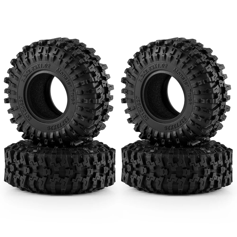A pair of black mud terrain rubber tires for RC crawlers, shown from the top.