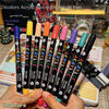 A hand holds a set of dual-tip acrylic paint markers featuring 48 vibrant colors for art and craft.