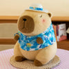 A fluffy beige capybara plush toy wearing a blue patterned shirt and sitting on a woven mat.
