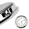 A close-up view of a silver mini car vent quartz clock with luminous hands.