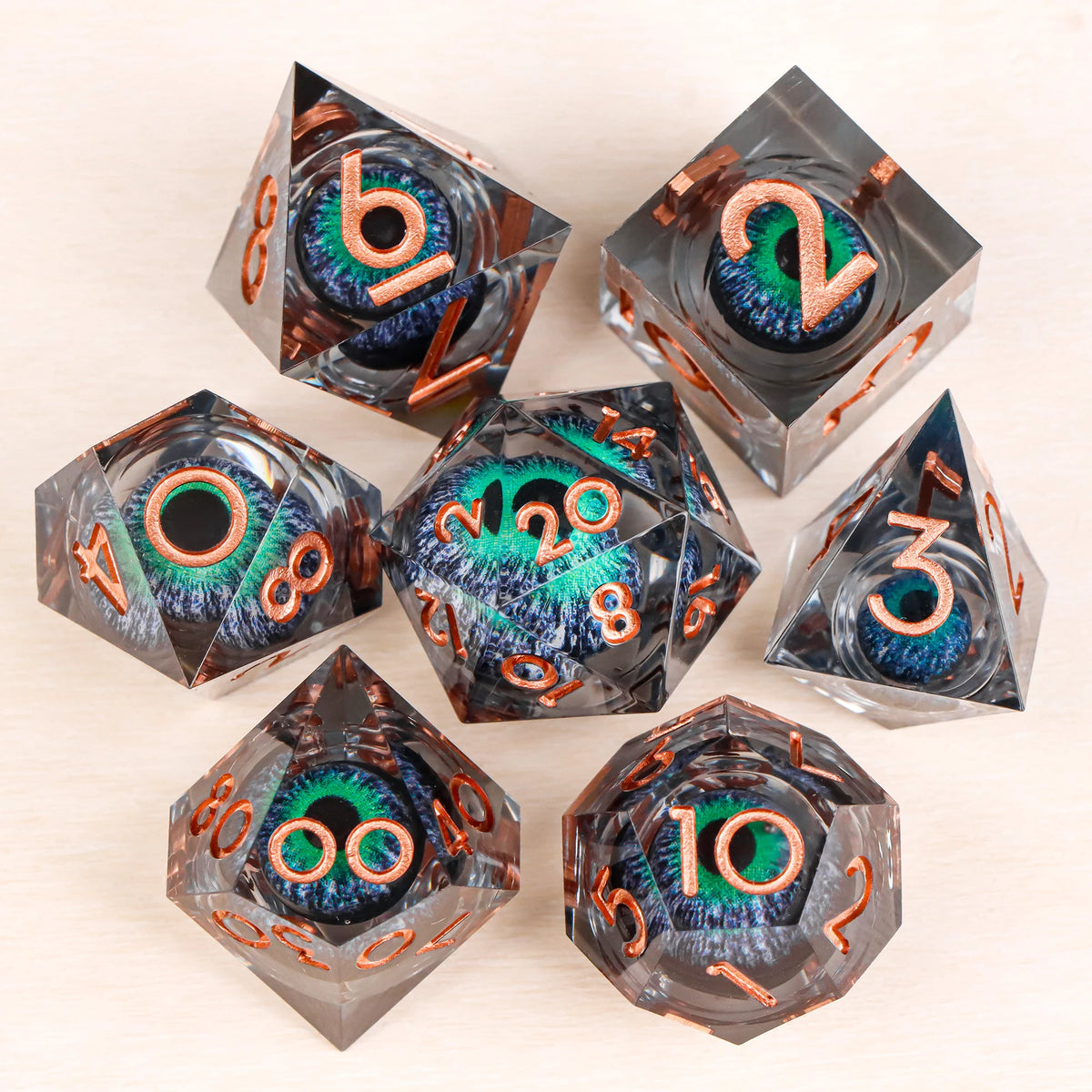 A set of liquid core resin dice featuring a dragon eye design in various angles and colors.