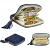 A navy velvet jewelry organizer bag with a gold zipper and tassel, displaying stacked gold jewelry.