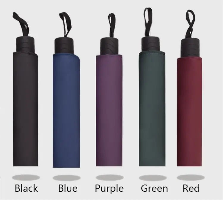 A row of five folding umbrellas in black, blue, purple, green, and red colors.