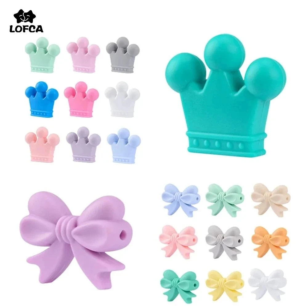 A collection of food-grade silicone crown beads in various colors including teal, purple, pink, and white.