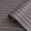 Roll of gray wood grain peel-and-stick wallpaper showing a linear pattern.