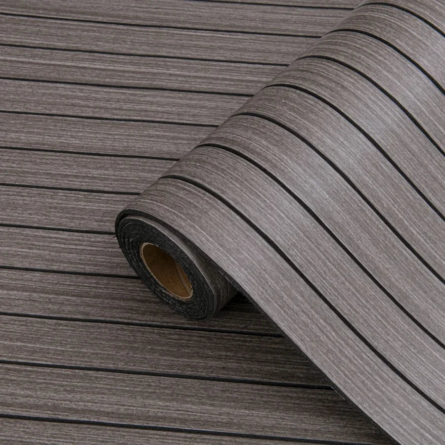 Roll of gray wood grain peel-and-stick wallpaper showing a linear pattern.