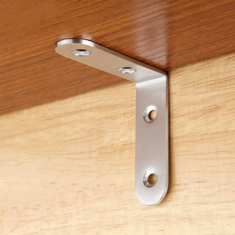 A silver stainless steel 90-degree angle bracket mounted on a wooden surface.