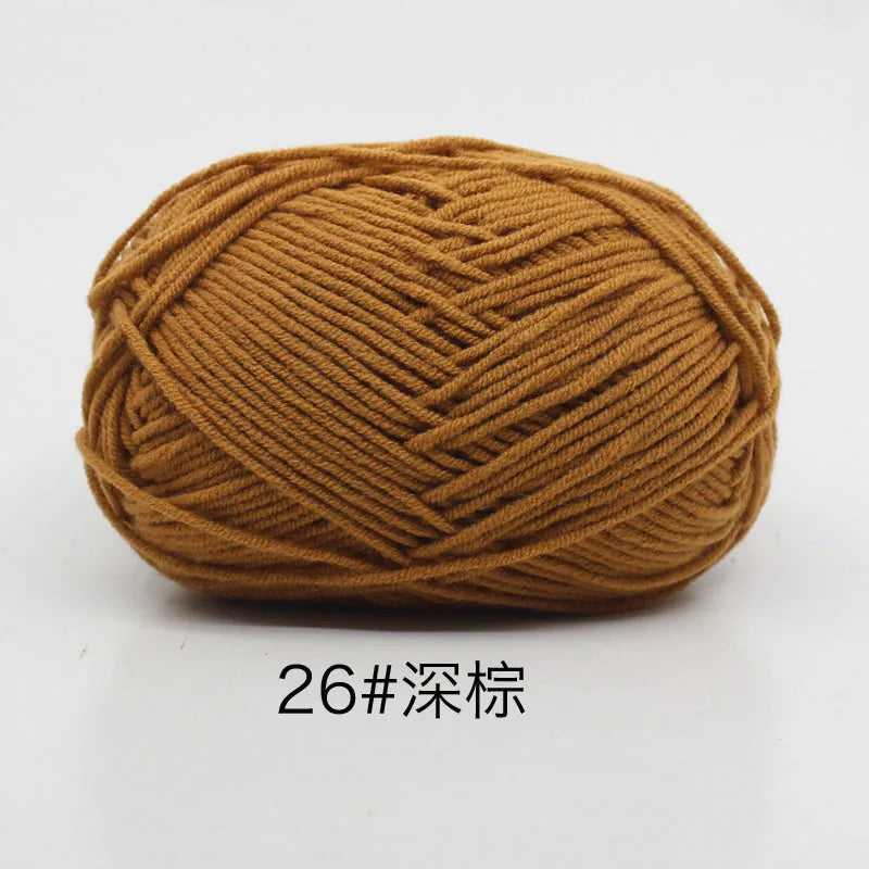 A ball of soft 4-ply milk cotton yarn for knitting and crochet in a warm brown color.