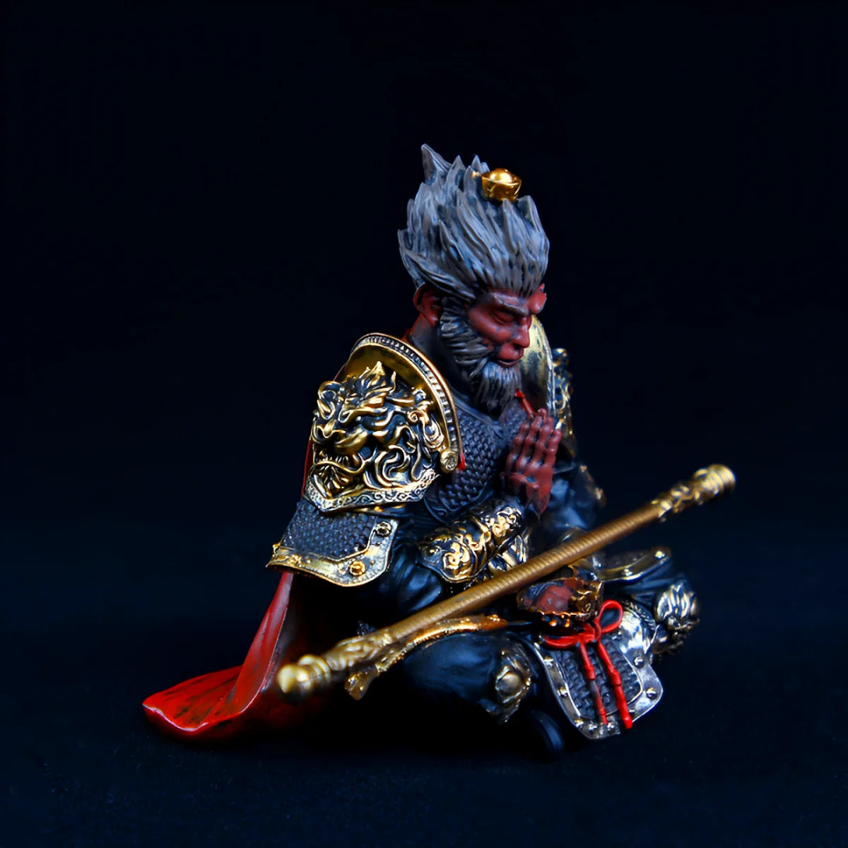 Hand-painted Monkey King figurine with staff, featuring dark armor and a red cloth.