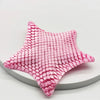 A pink 3D printed articulated starfish fidget toy with a textured, woven surface.