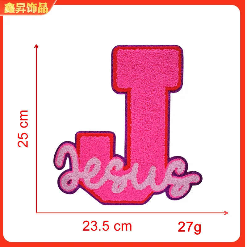 Pink embroidered iron-on patch shaped like the letter T with the word Jesus underneath