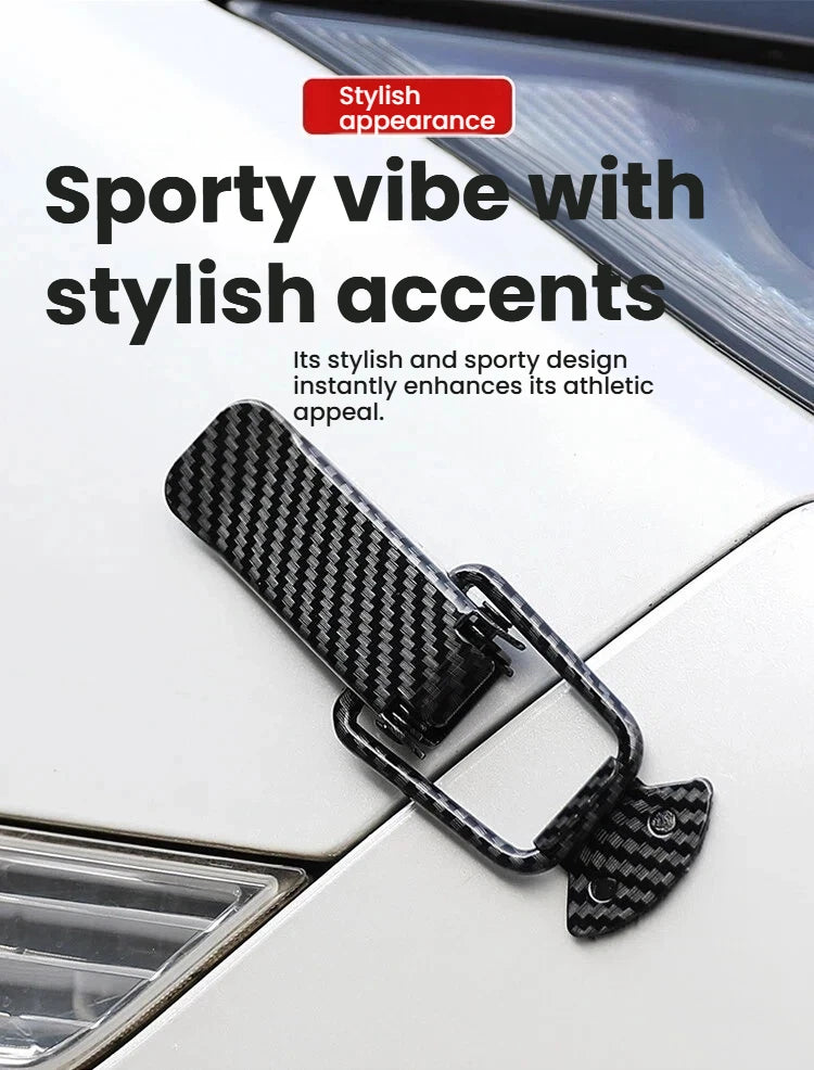 A close-up of a black carbon fiber alloy hood pin lock kit installed on a white car surface.