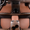 Interior view of a car showing five waterproof leather floor mats with quilted stitching and a central console.