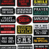 A collection of black embroidered iron-on letter patches with various phrases like Sarcasm and Prayer