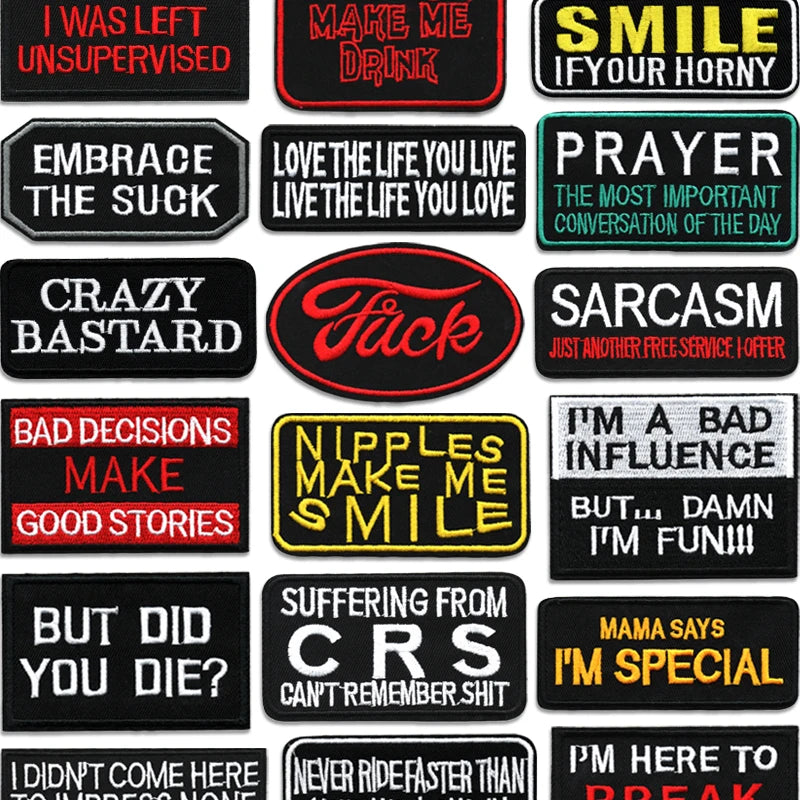 A collection of black embroidered iron-on letter patches with various phrases like Sarcasm and Prayer