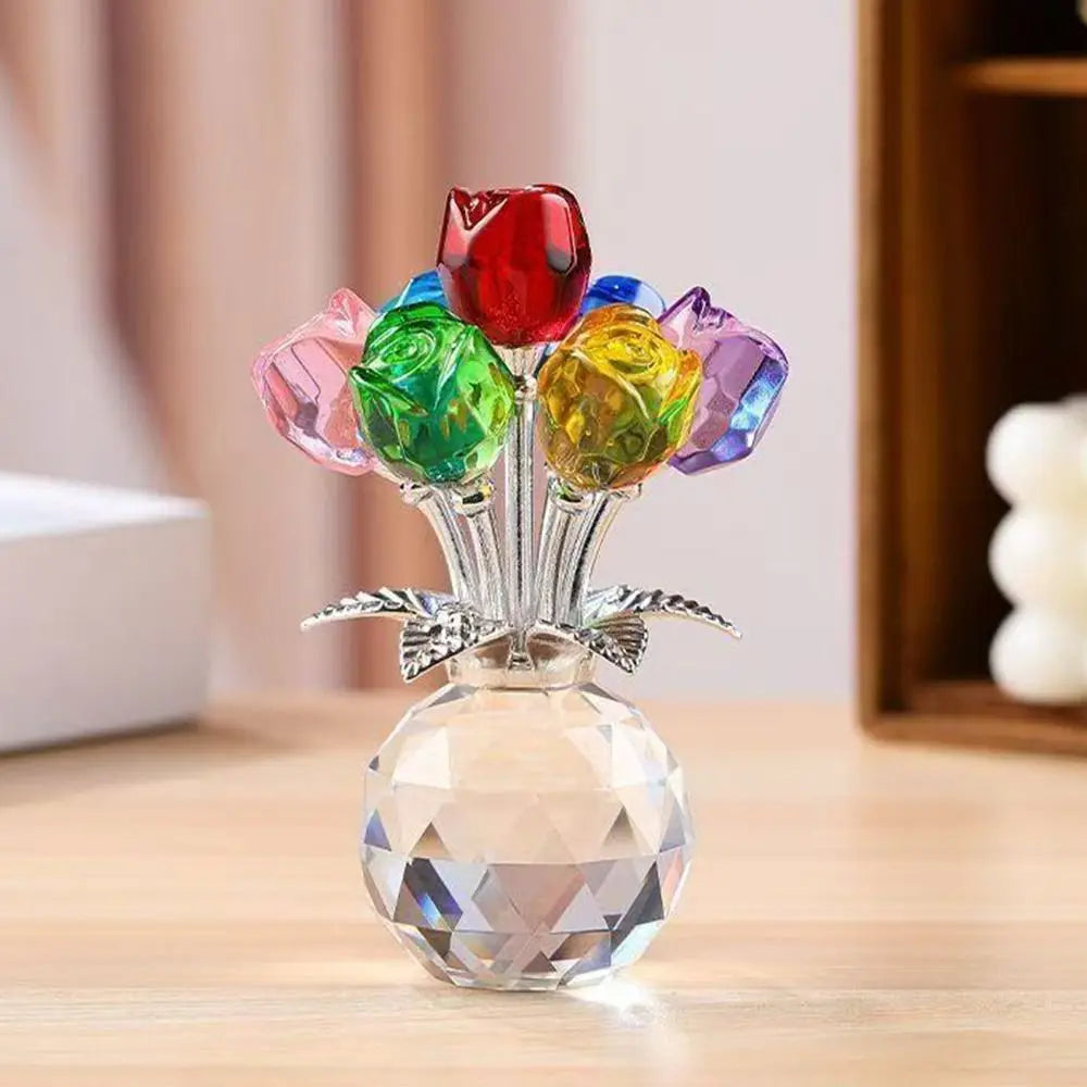 A crystal sculpture featuring a bouquet of colorful, reflective glass roses displayed in a clear base.