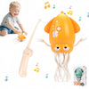 An orange interactive musical dancing toy with light show and a white puppet-like figure.