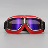 A pair of red retro foldable motorcycle goggles with a black strap and purple-tinted lenses.
