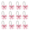 A set of twelve pink decorative bow tie shower curtain hooks.