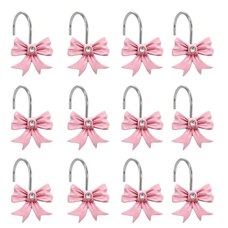 A set of twelve pink decorative bow tie shower curtain hooks.