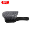 A single gray car cleaning brush with a black handle.