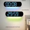 A wall-mounted digital clock displaying 00:08, 29:59, and a chronograph function on a light gray wall.