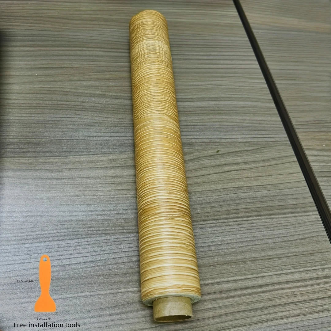 A roll of self-adhesive wood grain cabinet and furniture refacing film is shown on a gray wooden surface.