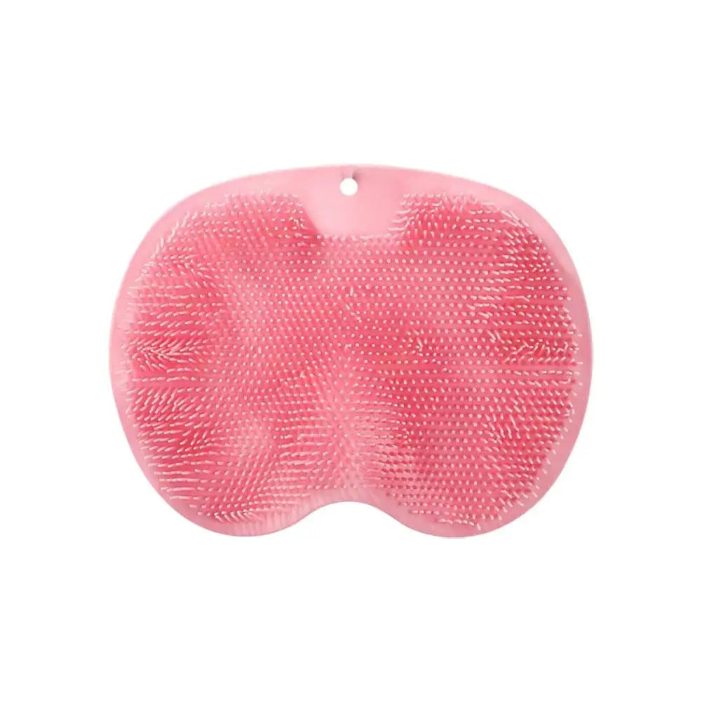A pink ergonomic silicone foot scrubber with a suction base.