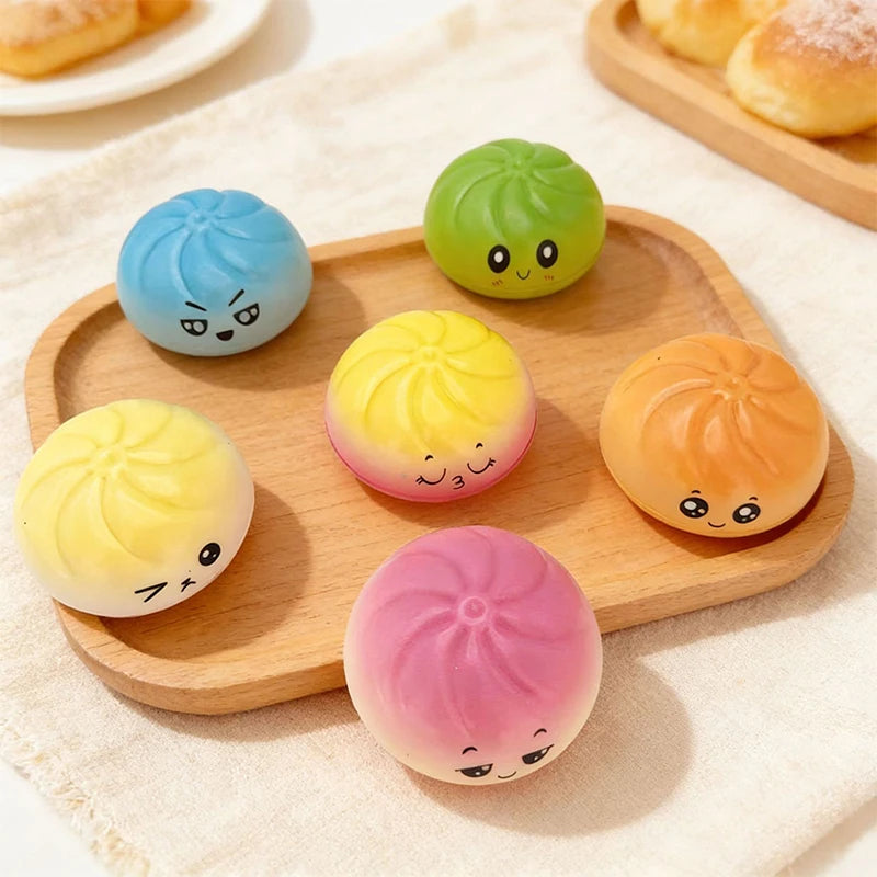 A set of colorful squishy stress relief toys in various pastel shades arranged on a wooden board.