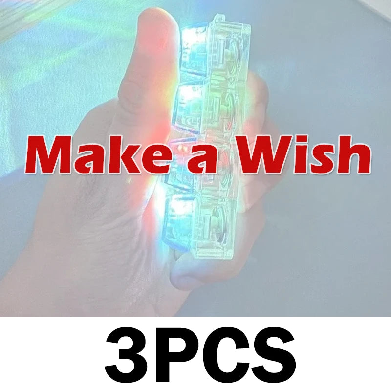 A hand holds a clear, light-up keyboard keychain fidget toy with three pieces.