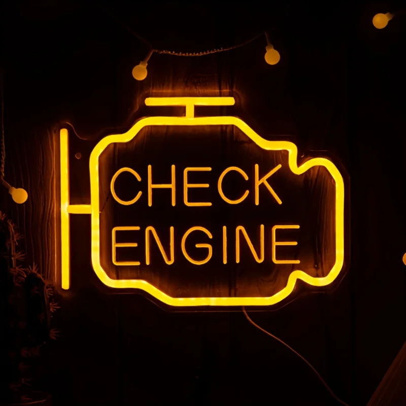 A glowing yellow neon sign shaped like an engine with the words CHECK ENGINE displayed on a dark background.