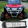 A close-up view of a black LED flood light pod mounted on the front of a red truck or SUV.