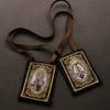 A brown leather cord necklace with an embroidered pendant featuring the Immaculate Heart of Mary.