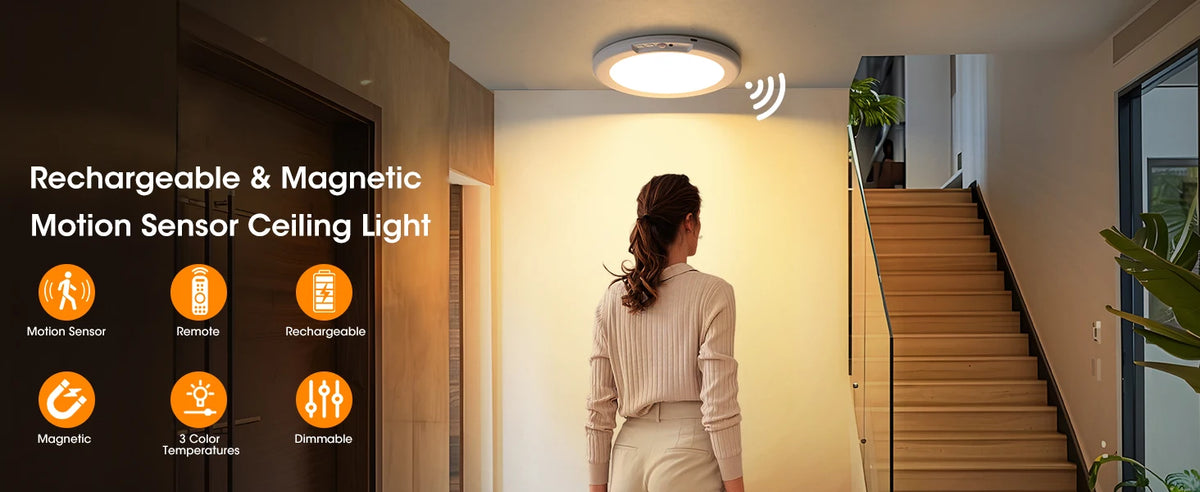 A woman stands near a modern staircase with a rechargeable and magnetic motion sensor ceiling light installed above.