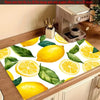 A yellow lemon print absorbent kitchen drying mat featuring lemons and green leaves.