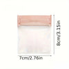 A clear, self-sealing cosmetic bag with a pink/nude colored seal and dimensions of 8cm by 7cm.