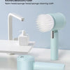 A light blue cordless electric spin scrubber with interchangeable brush heads cleaning stains on a marble surface.