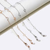 A delicate gold and silver star and moon pendant necklace chain displayed on a white background.