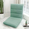 A light sage green foldable floor sofa cover for a single seat or lounger placed on a white surface.