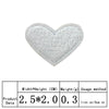 A white heart shaped embroidered iron-on patch with a textured surface.