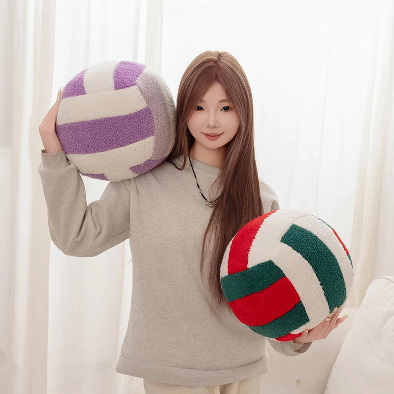 A young woman holds a purple and white striped simulation volleyball plush toy pillow.