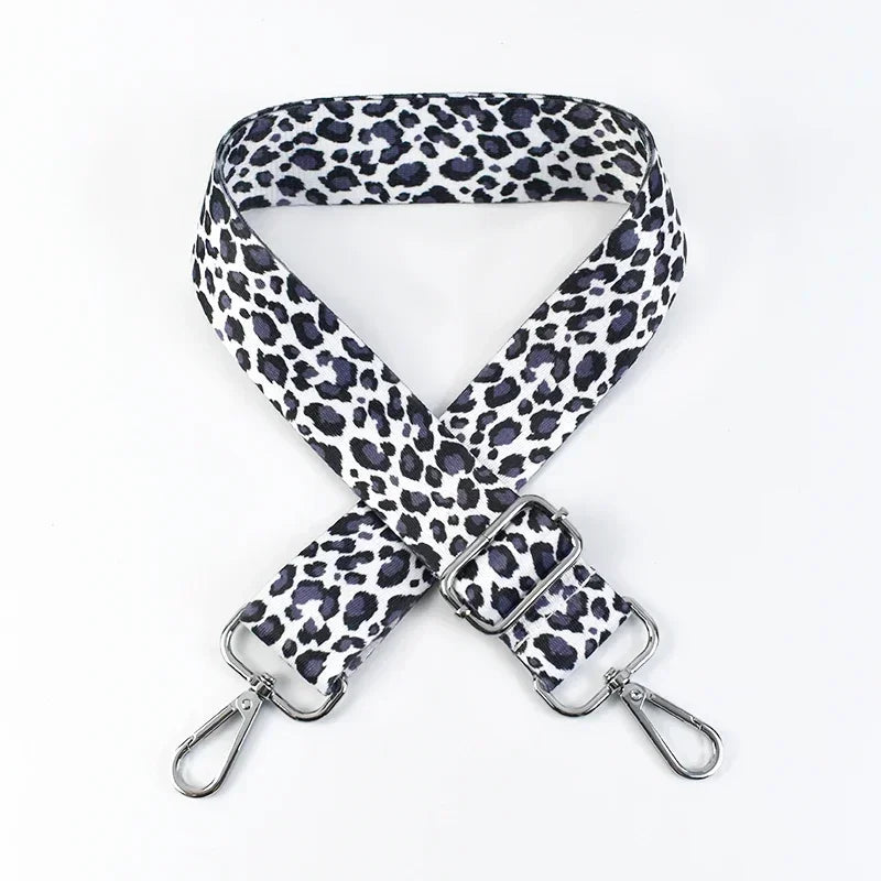 A black and white leopard print wide adjustable crossbody bag strap.