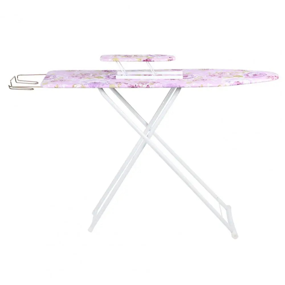 A pink floral ironing board with a metal stand and ironing accessories.