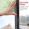 A hand is peeling off a self-adhesive invisible mosquito screen from a window frame.